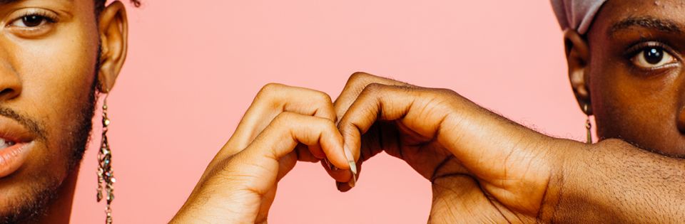 Two people making heart symbol with hands